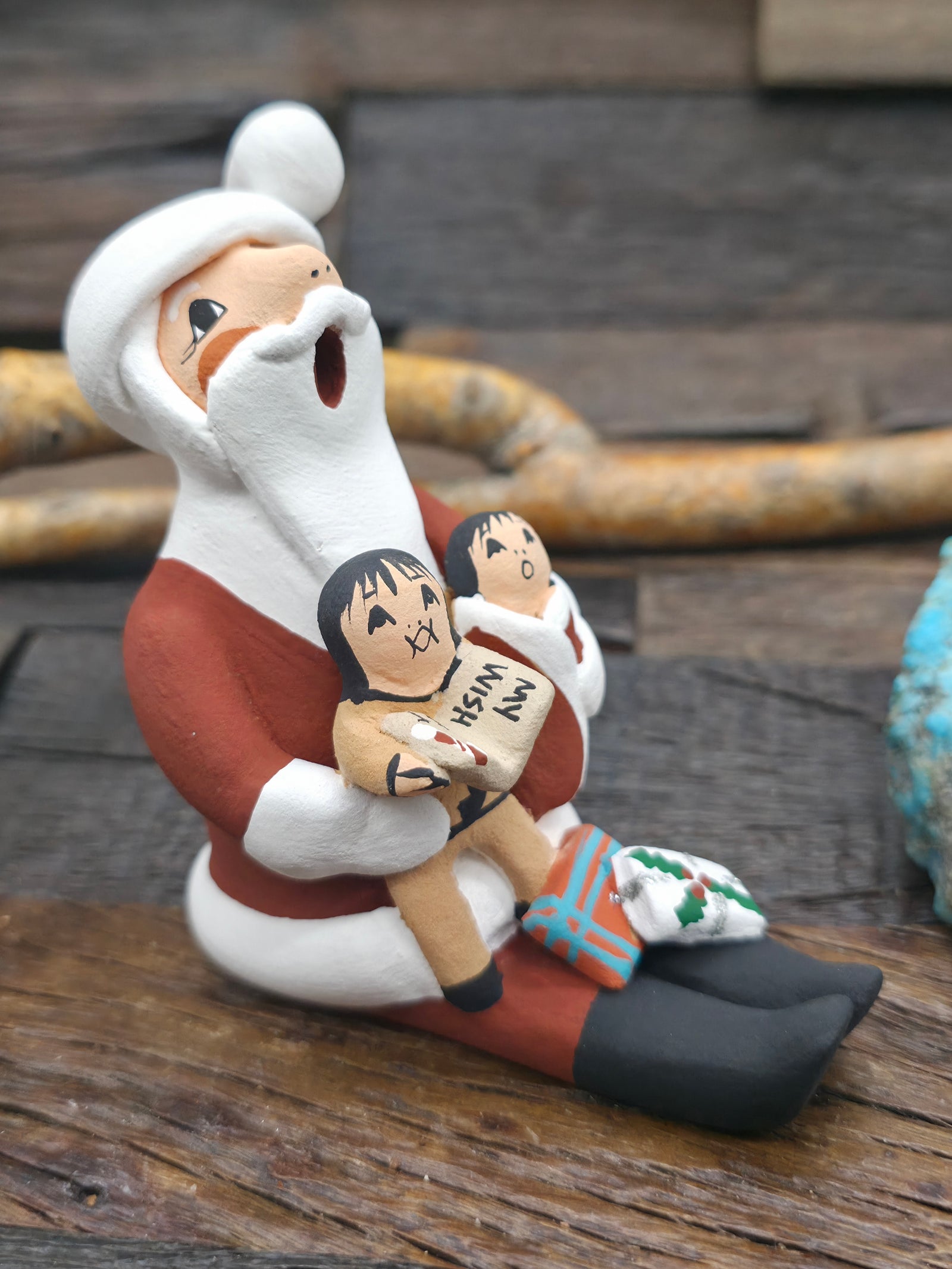 Seated Santa Claus Jemez Storyteller Figurine by D. Lucero - 4 in. by 2 in. by 3 1/2 in.