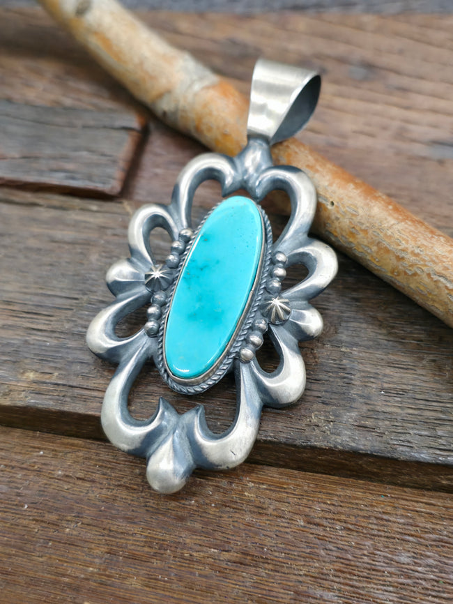 Cast Sterling Silver and Turquoise Pendant by Harrison Bitsue