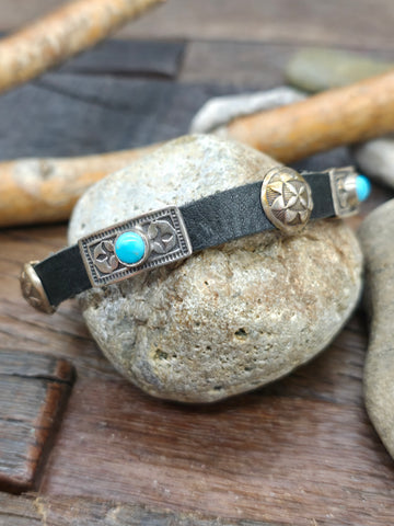 Black Leather Bracelet with Circular Sterling Silver Conchos and Single Rectangular Blue Turquoise Concho by Rick Montaño - 8 in. - Designs Vary