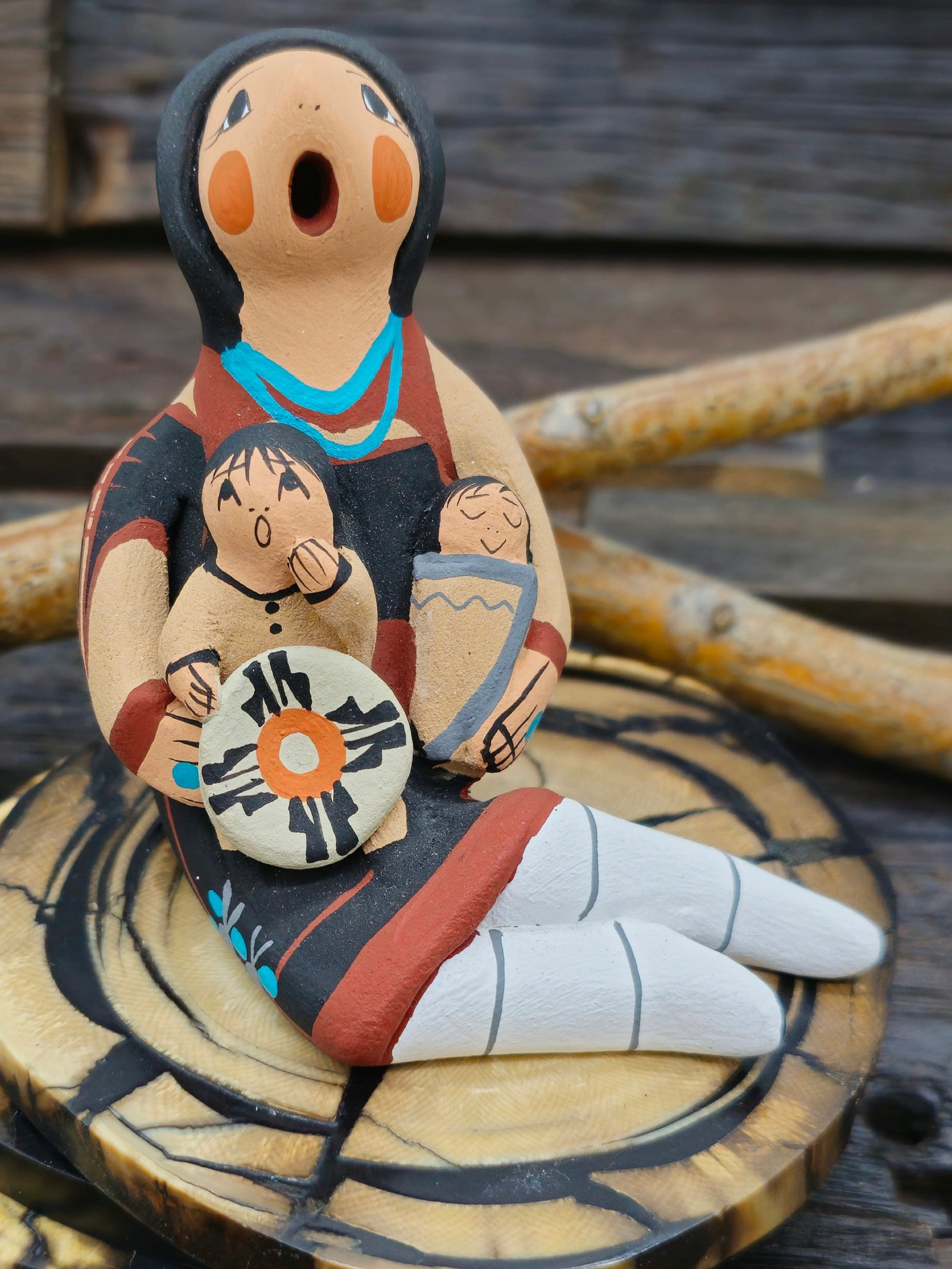Jemez Storyteller Figurine with Two Children and Basket, made by D. Lucero - 3 1/4" by 3 1/4" by 2 1/2"